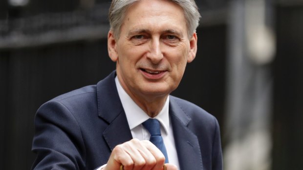 Britain's Chancellor of the Exchequer Philip Hammond with his traditional red dispatch box outside No 11 Downing Street, his official residence.