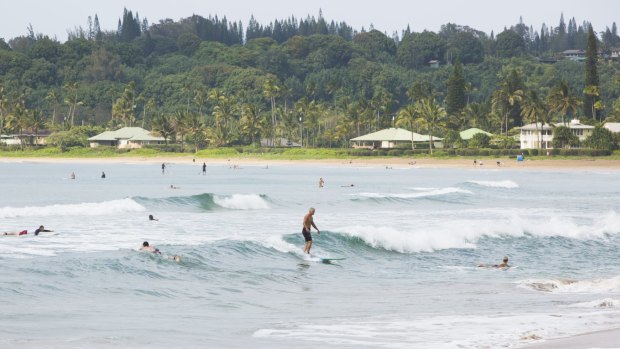 Surfers enjoy the water at Hanalei Bay.