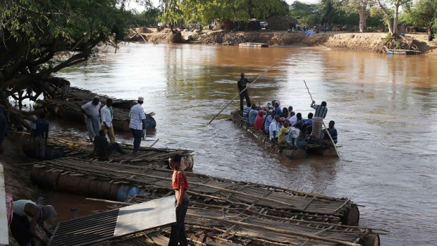 : People use rafts to cross the Dawa river bordering Kenya and Ethiopia. 