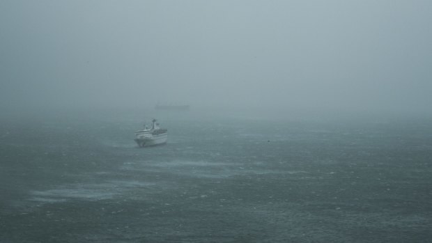 Waves break around a ship during a No.10 Hurricane Signal raised for Typhoon Hato in Hong Kong on Wednesday.