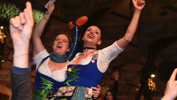 Waitresses celebrate after closing of a tent on the last day of the Oktoberfest beer festival in Munich, southern Germany. 