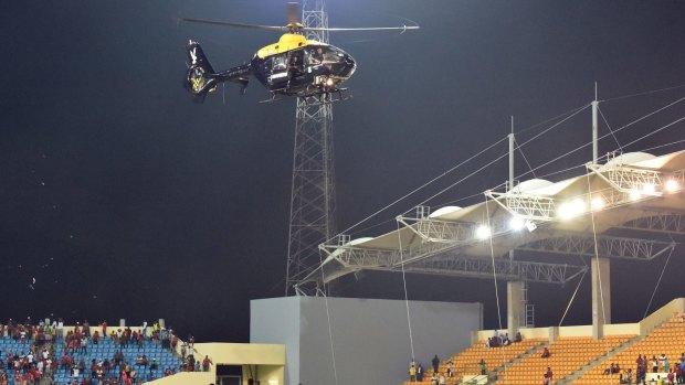 A police helicopter flies over the statdium during an interruption of the 2015 African Cup of Nations semi-final 