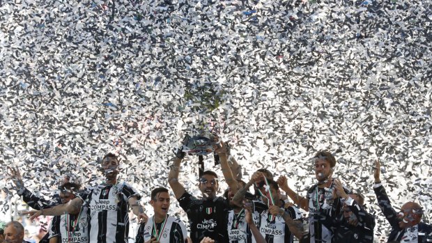 Juventus players celebrate winning an unprecedented sixth consecutive Italian title.