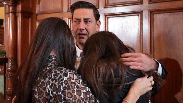 Support: Andy Woodward is comforted by his partner Zelda Worthington and stepdaughter Isabella at the launch of the Offside Trust at the Midland Hotel in Manchester. 