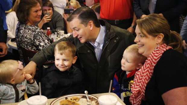 Senator Ted Cruz talks with Elizabeth Craig's children during campaigning in Osceola, Indiana. 