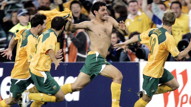 Glory boys: John Aloisi charges down the sideline after his famous penalty against Uruguay at ANZ Stadium in 2005.