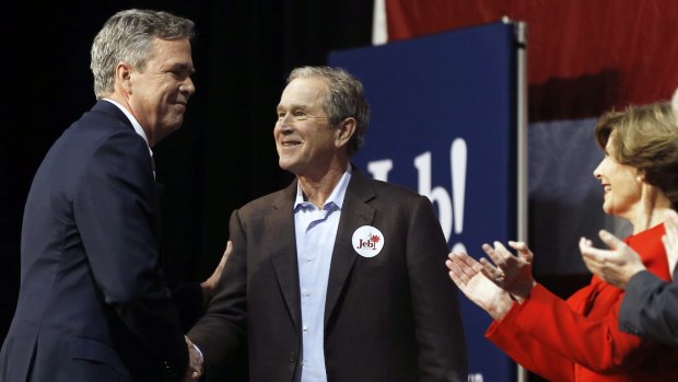 Republican presidential candidate and former Florida governor Jeb Bush, left, shakes hands with his brother, former president George W. Bush.