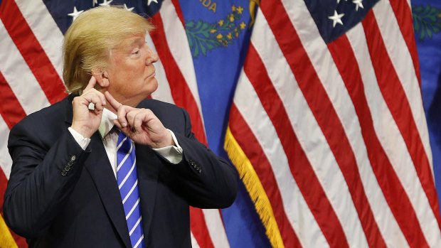 'I can't hear you': Republican presidential candidate Donald Trump eggs on his supporters during a rally in Las Vegas. 