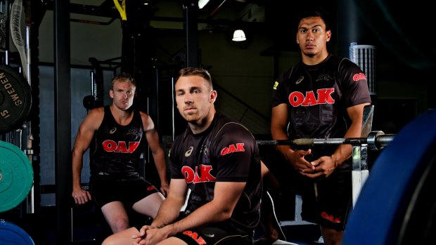 Back in black: Peter Wallace, Bryce Cartwright and Elijah Taylor.
