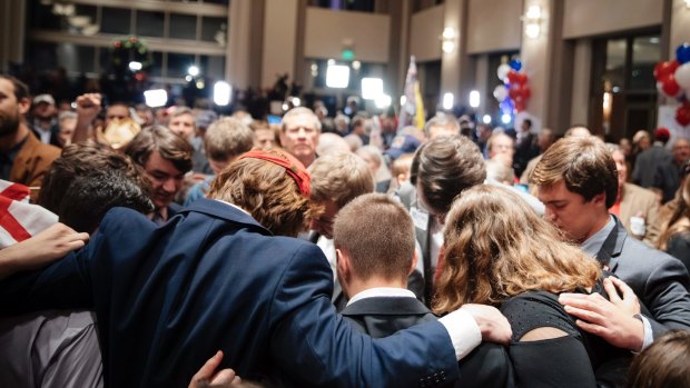 Supporters of Roy Moore pray at an election night gathering in Alabama.