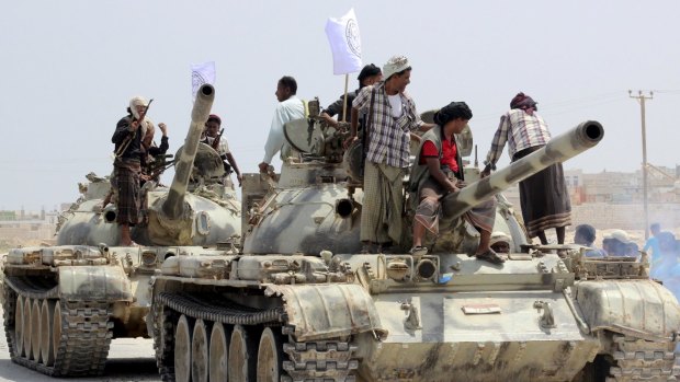 Tribesmen stand on tanks they took from army bases in Shihr city in Yemen's eastern Hadramawt province on Saturday.