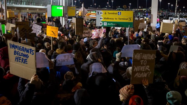 Demonstrators gather outside JFK airport to protest Trump's executive order.