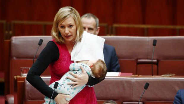 Senator Larissa Waters puts forward a motion in the Senate while breastfeeding her baby Alia.