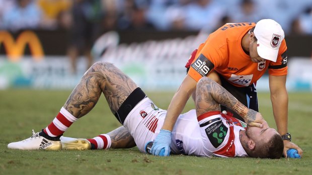 Josh Dugan of the Dragons receives attention from the trainer during the round three NRL match between the Cronulla Sharks and the St George Illawarra Dragons.