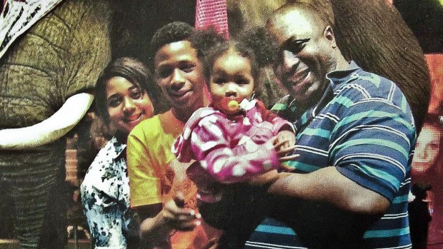 Death by police choke hold: Eric Garner, right, poses with his children during a family outing.