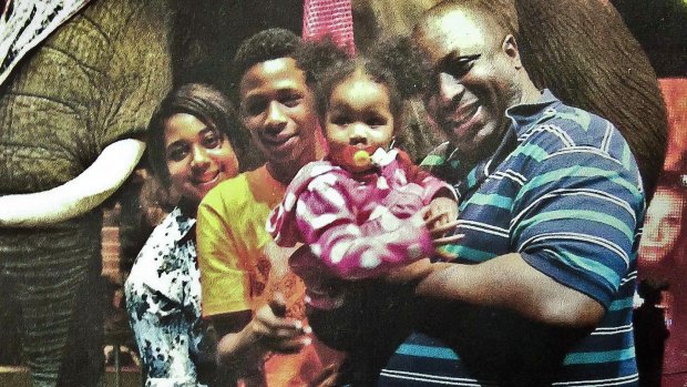 Death by police chokehold: Eric Garner, right, poses with his children during a family outing.