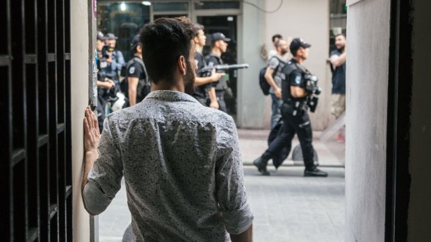 Husein Sabat watches as police patrol a street in a scene from the documentary Mr Gay Syria, which will be screened at the Antenna Documentary Film Festival.