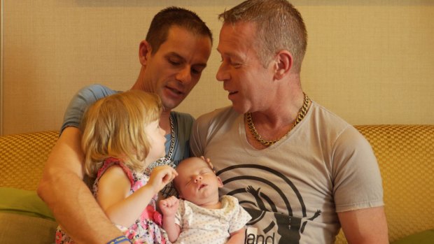 James, left, with Steven and their newborn Rhyley and two-year-old daughter Aleisha, in Bangkok.