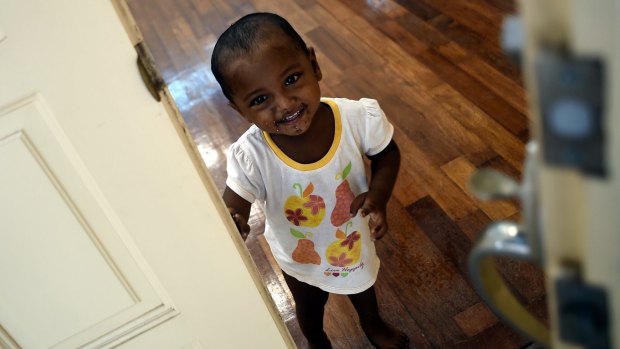 A Rohingya child peeps out of a door at the temporary detention centre in Langkawi.