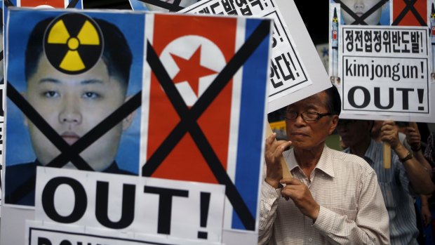 A man from a conservative civic group holds up a banner depicting North Korean leader Kim Jong-un during an anti-North Korean rally in central Seoul, South Korea, on Friday.