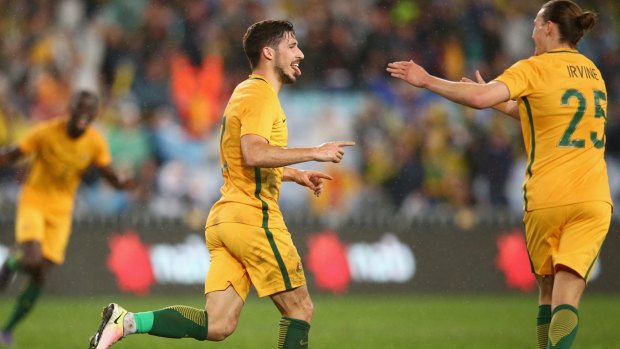 Solid gold: Mathew Leckie celebrates his last-gasp matchwinner.