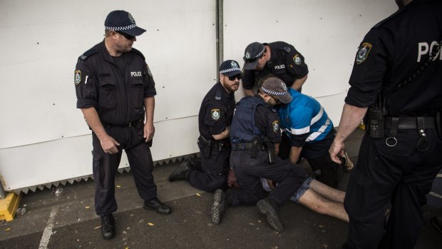 Police attend to a festivalgoer at Sydney Olympic Park.