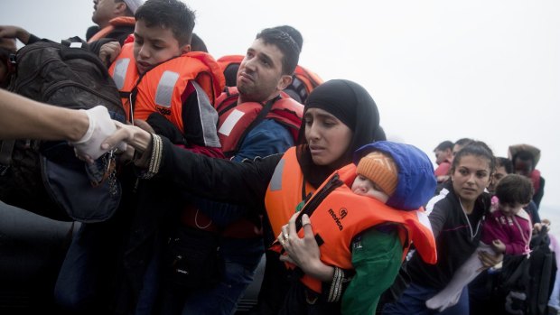 Refugees arrive on Lesbos on Wednesday after crossing the Aegean Sea from Turkey on an inflatable dinghy.