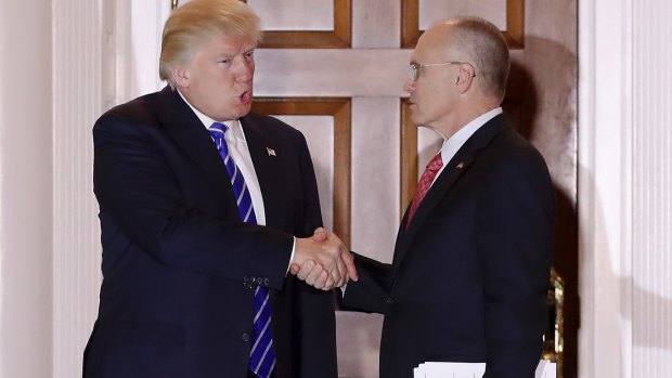 Donald Trump and Andrew Puzder, chief executive of CKE Restaurants, shake hands in a photo taken in November.