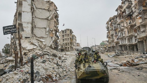 Russian troops in the devastated Syrian city of Aleppo. 