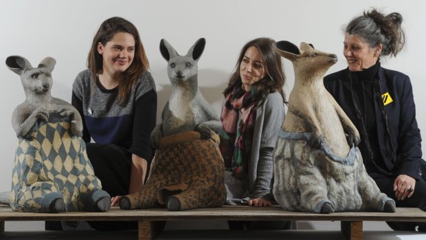 Australian Ceramics Triennale project managers Yasmin Masri (left) and Gwenyth Macnamara with chairwoman Avi Amesbury, pictured with Bev Hogg’s work <i>Wooly Jumpers 1</i>, <i>2</i> and <i>3</i>, which feature in Craft ACT’s exhibition Stomping Ground, in the ACT Legislative Assembly gallery. 