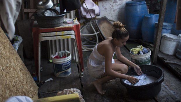Marilia da Silva, 14, washes her clothes in a slum in Recife, Brazil. The Zika virus, spread by the Aedes aegypti mosquito, thrives in people's homes and can breed in even a bottle cap's-worth of stagnant water.