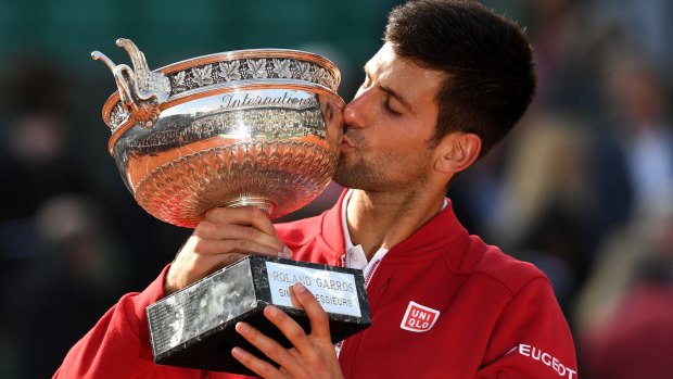 Two down, two to go: Djokovic with the French Open trophy.