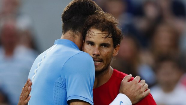 Juan Martin del Potro, felt, and Rafael Nadal hug after their semifinals on Saturday.