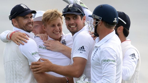 James Anderson, left, celebrates along with Alastair Cook, third from right, and other teammates after his side took a wicket during the first Test.