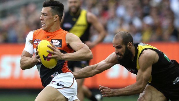 Big loss: Dylan Shiel, who later had to leave the field, gets away from Bachur Houli.