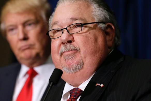 Sam Clovis speaks during a news conference as then-Republican presidential candidate Donald Trump, left, watches before a campaign rally in Dubuque, Iowa. 