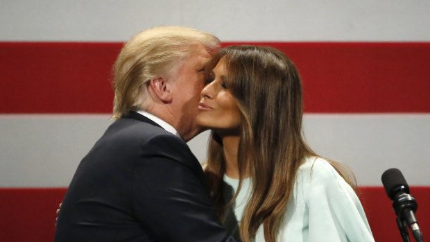 Republican presidential candidate, Donald Trump, left, kisses his wife Melania.
