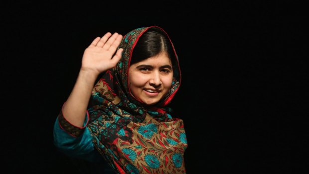 Malala Yousafzai waves to the crowd at a press conference at the Library of Birmingham after being announced as a recipient of the Nobel Peace Prize, on October 10, 2014 in Birmingham, England.