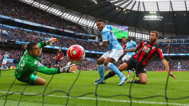 Raheem Sterling of Manchester City scores his team's first goal past Adam Federici of Bournemouth.