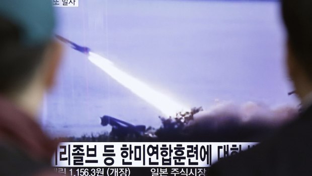 People  in Seoul, South Korea, watch a TV screen showing file footage of a missile launch conducted by North Korea.