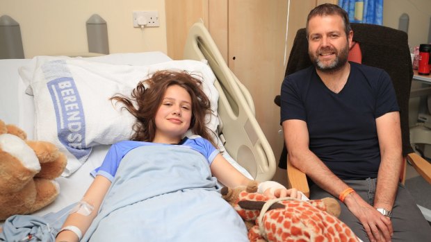 Evie Mills, 14 from Harrogate, a victim of Manchester Arena bombing with her dad, Craig as Queen Elizabeth II visits the Royal Manchester Children's Hospital.