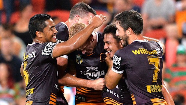 All smiles: Brisbane celebrate Kodi Nikorima's try.