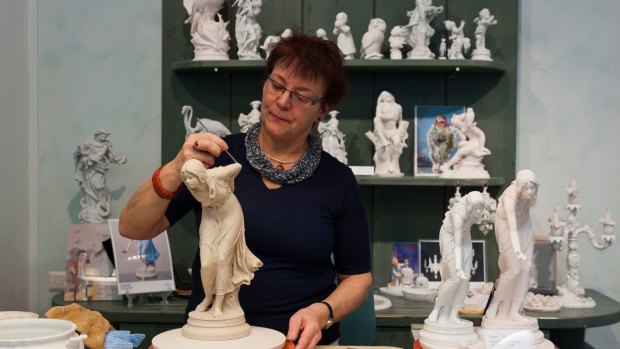 An artist demonstrates her craft at the Meissen porcelain museum. 