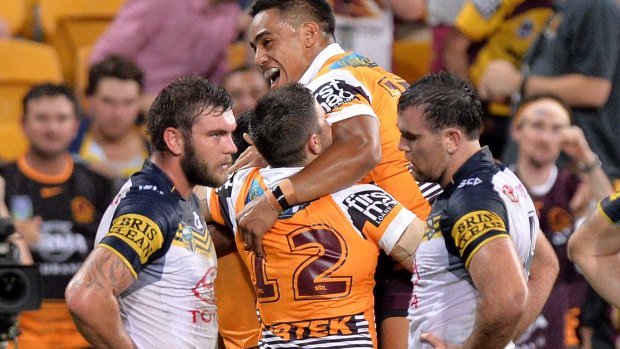 All doing their jobs:  Jordan Kahu of the Broncos is congratulated by teammates.