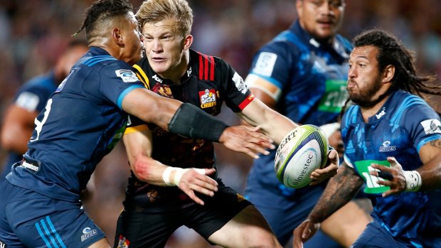 Speed to burn: Damian McKenzie enters the fray at Rugby Park in Hamilton.