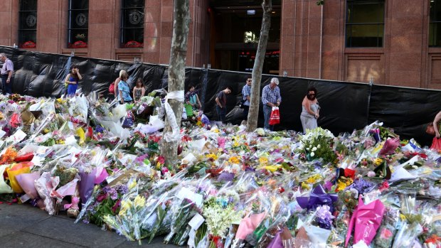 Flowers laid in tribute outside the Lindt Cafe following the December siege in which Katrina Dawson and Tori Johnson were killed.