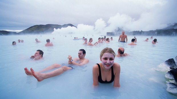 People relax in the Blue Lagoon, a natural geothermal field which gets its colour from the white silica mud and blue algae.