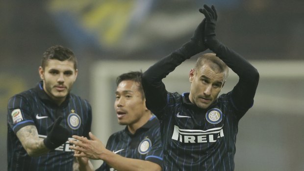 Inter Milan's Rodrigo Palacio, right, celebrates with his teammates Mauro Icardi, left, and Yuto Nagatomo at the end of the match.