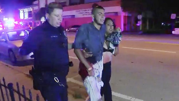 An injured man is escorted out of the Pulse nightclub after the deadly shooting. 