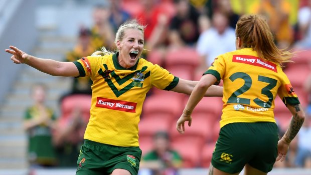 Giant leap for women's rugby league: Ali Brigginshaw and Caitlin Moran celebrate after winning the World Cup final.